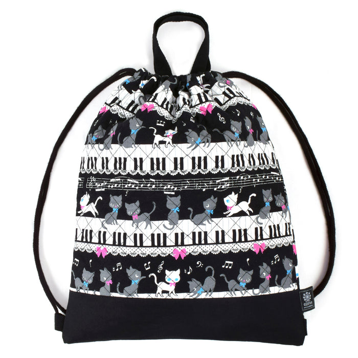 Black cat waltz dancing on a knapsack quilted piano (black) 