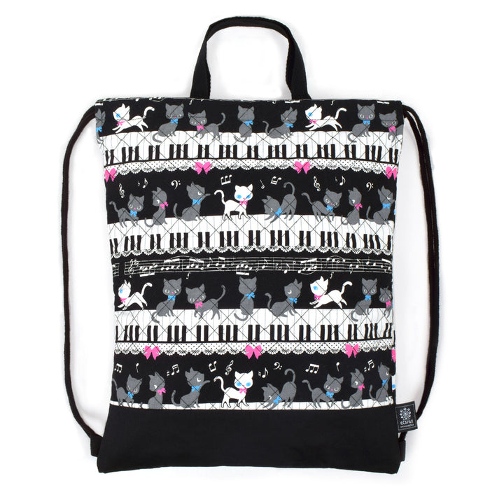 Black cat waltz dancing on a knapsack quilted piano (black) 